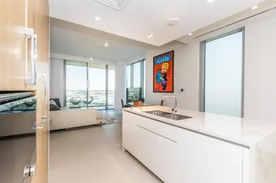 a kitchen and living room with a sink and a couch at Luxury 3BDR Ellington House Dubai Hills in Dubai