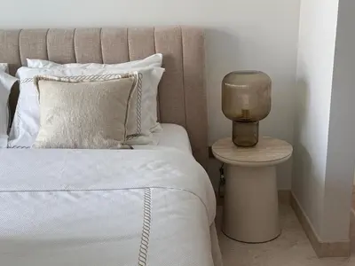 a bedroom with a bed and a nightstand with a lamp at 1 BR apartment in Ellington Beach House in Dubai
