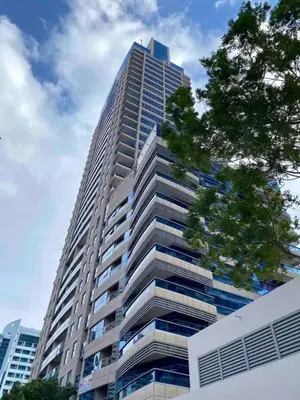a tall building with a tree in front of it at Dubai Marina 5 min to the beach in Dubai