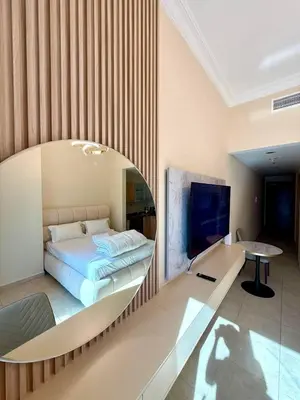 a bedroom with a bed and a desk and a tv at Dubai Marina 5 min to the beach in Dubai