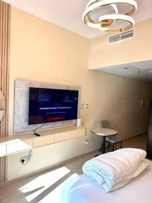 a bedroom with a flat screen tv on a wall at Dubai Marina 5 min to the beach in Dubai