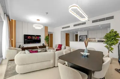 a living room with a couch and a table at Neat 3BR Habour Views with Balcony-Burj Khalifa View, Pool, Gym and Modern Facilities in Dubai