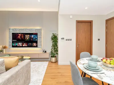 a living room with a couch and a table at Livora Stays - Dubai Marina With Balcony & Water Views in Dubai