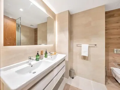 a bathroom with a white sink and a shower at Livora Stays - Dubai Marina With Balcony & Water Views in Dubai