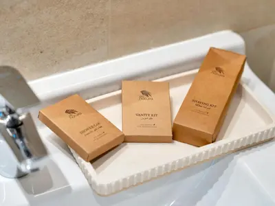 three boxes sitting on a tray in a bath tub at Livora Stays - Dubai Marina With Balcony & Water Views in Dubai