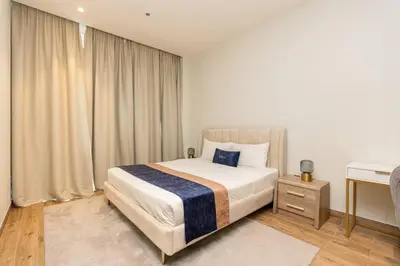 a bedroom with a bed and a desk in it at CitiHome - Stunning 5-Star Suite Jumeirah Living in Dubai