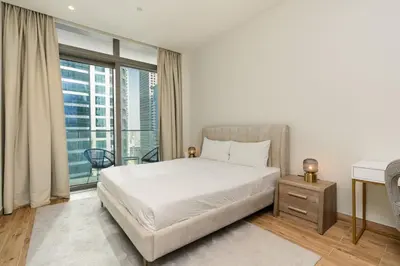 a bedroom with a bed and a large window at CitiHome - Stunning 5-Star Suite Jumeirah Living in Dubai