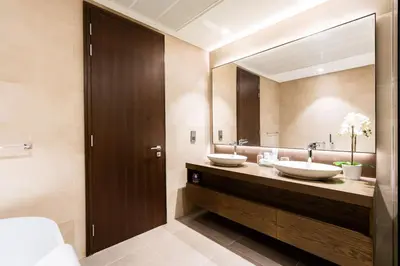 a bathroom with two sinks and a large mirror at CitiHome - Stunning 5-Star Suite Jumeirah Living in Dubai