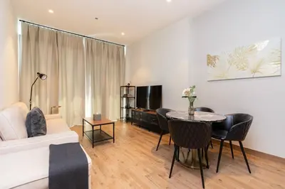 a living room with a couch and a table at CitiHome - Luxurious Marina View - Jumeirah Living in Dubai