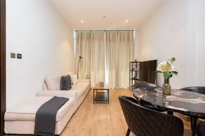a living room with a couch and a table at CitiHome - Luxurious Marina View - Jumeirah Living in Dubai