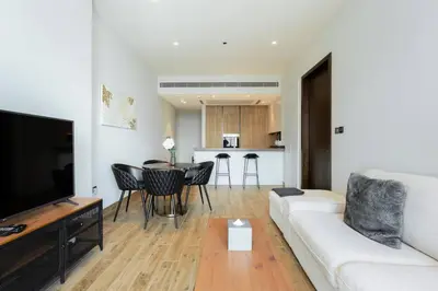 a living room with a white couch and a table at CitiHome - Luxurious Marina View - Jumeirah Living in Dubai