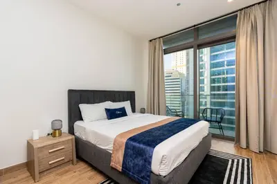 a bedroom with a bed and a large window at CitiHome - Iconic 1BR Jumeirah Living Marina Gate in Dubai