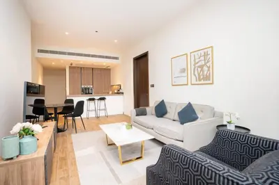 a living room with a couch and a table at CitiHome - Iconic 1BR Jumeirah Living Marina Gate in Dubai