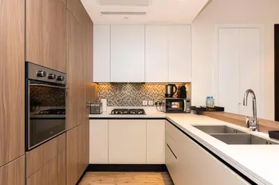 a kitchen with white cabinets and a sink at CitiHome - Iconic 1BR Jumeirah Living Marina Gate in Dubai