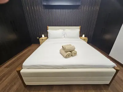 a bedroom with a bed with two towels on it at Newly Upgraded 3-BR close to Barasti Beach in Dubai