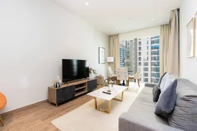 a living room with a couch and a tv at CitiHome - Elegant Retreat in Dubai Marinas Heart in Dubai