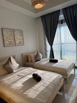 a bedroom with two beds and a window at 3 bedroom 51st floor Panoramic ocean views in Dubai