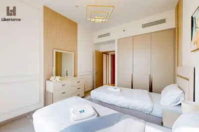 a bedroom with two beds and a mirror at Best Burj khalifa View 2 Mins Dubai Mall Like home in Dubai