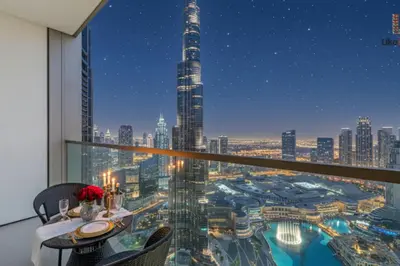 a room with a view of a city at night at BEST BURJ VIEW IN DUBAI DOWNTOWN 2BR in Dubai