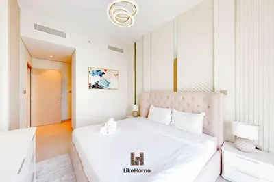 a bedroom with a white bed with a pink headboard at BEST BURJ VIEW IN DUBAI DOWNTOWN 2BR in Dubai