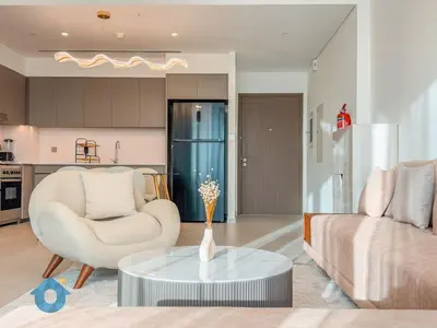 a living room with a couch and a table at Next to Burj Khalifa - Skyline Balcony Like home in Dubai