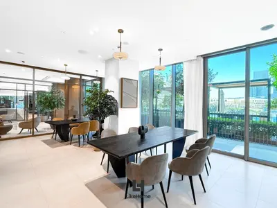 a dining room with tables and chairs and large windows at Next to Burj Khalifa - Skyline Balcony Like home in Dubai