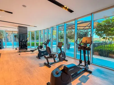 a gym with treadmills and exercise equipment in a building at Next to Burj Khalifa - Skyline Balcony Like home in Dubai