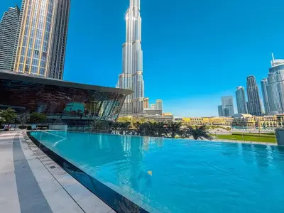 a large swimming pool with a city skyline in the background at Next to Burj Khalifa - Skyline Balcony Like home in Dubai