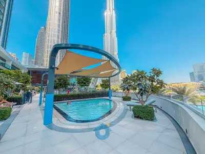 a swimming pool in a city with tall buildings at NEXT TO DUBAI MALL AND BURJ 2 BR SEA VIEW in Dubai