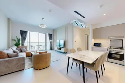 a kitchen and living room with a table and a couch at NEXT TO DUBAI MALL AND BURJ 2 BR SEA VIEW in Dubai