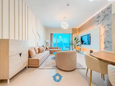 a living room with a couch and a table at BEST SEA VIEW NEXT TO BURJ KHALIFA AND DUBAI MALL in Dubai