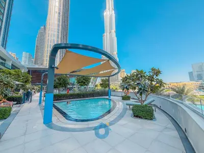 a swimming pool in a city with tall buildings at BEST SEA VIEW NEXT TO BURJ KHALIFA AND DUBAI MALL in Dubai