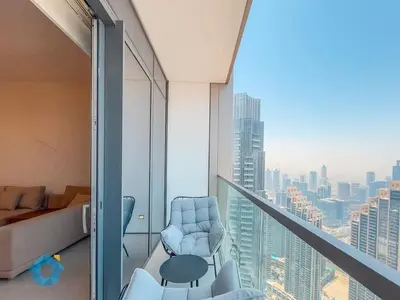 a room with a balcony with a view of a city at BEST SEA VIEW NEXT TO BURJ KHALIFA AND DUBAI MALL in Dubai