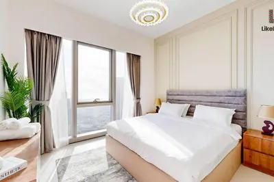 a bedroom with a large bed and a large window at 5 MINUTES BY WALK FROM BURJ ADN DUBAI MALL in Dubai