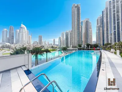 a swimming pool on the roof of a building with a city at 5 MINUTES BY WALK FROM BURJ ADN DUBAI MALL in Dubai