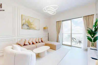a white living room with a couch and a table at NEXT TO BURJ KHALIFA AND DUBAI MALL in Dubai
