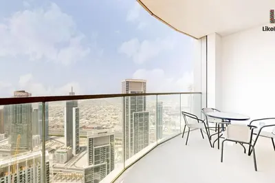 a balcony with a table and chairs and a view of the city at NEXT TO BURJ KHALIFA AND DUBAI MALL in Dubai