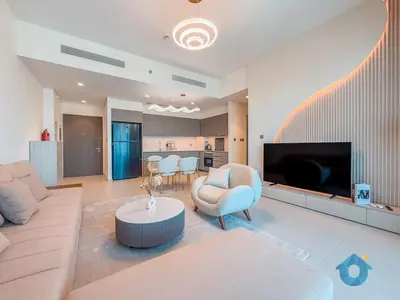 a large living room with a couch and a table at Direct Burj Khalifa View Near Dubai Mall Like Home in Dubai
