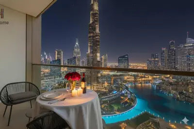 a table with a view of a city at night at BEST VIEW IN DUBAI BURJ KHALIFA VIEW in Dubai