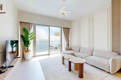 a living room with a couch and a tv at BEST VIEW IN DUBAI BURJ KHALIFA VIEW in Dubai