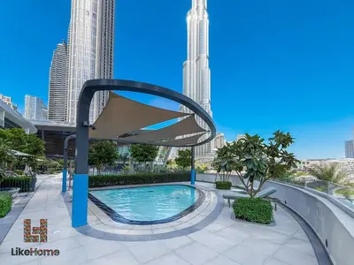 a swimming pool in a city with tall buildings at NEXT TO BURJ KHALIFA AND DUBAI MALL ONLY 2 MINUTES AWAY in Dubai