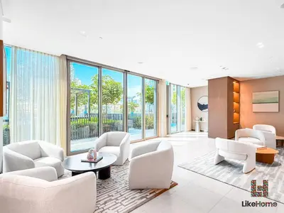 a living room with white furniture and large windows at BEST LOCATION 2 MINUTES AWAY FROM BURJ KHALIFA in Dubai