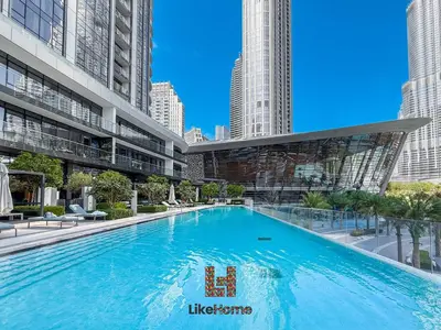 a large swimming pool in a building with tall buildings at BEST LOCATION 2 MINUTES AWAY FROM BURJ KHALIFA in Dubai