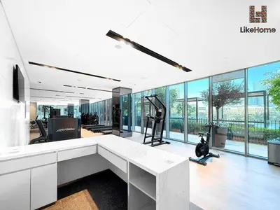 an office with a large white desk and large windows at Exclusive Burj Khalifa View 3BR SkyManson LikeHome in Dubai