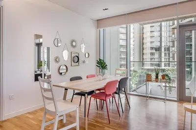 a dining room with a table and chairs at StayShort - Bluewaters Finest Elegant 1BR Apartment - Beach Lifestyle in Dubai