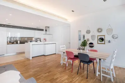 a kitchen and dining room with a table and chairs at StayShort - Bluewaters Finest Elegant 1BR Apartment - Beach Lifestyle in Dubai
