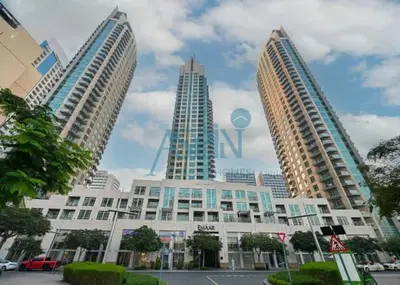 three tall buildings with a sign on top of it at Aspin Stylish Burj Views Studio-City View in Dubai