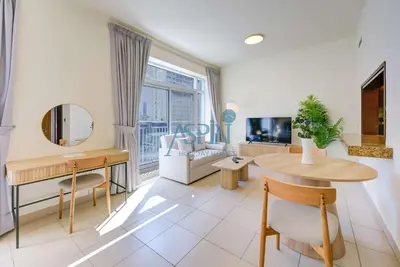 a living room with a table and a couch at Aspin Stylish Burj Views Studio-City View in Dubai