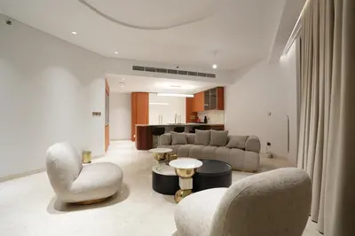 a living room with a couch and chairs and a table at Spacious 2BR Near Beach Ellington in Dubai