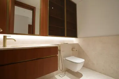 a bathroom with a toilet and a sink and a mirror at Spacious 2BR Near Beach Ellington in Dubai